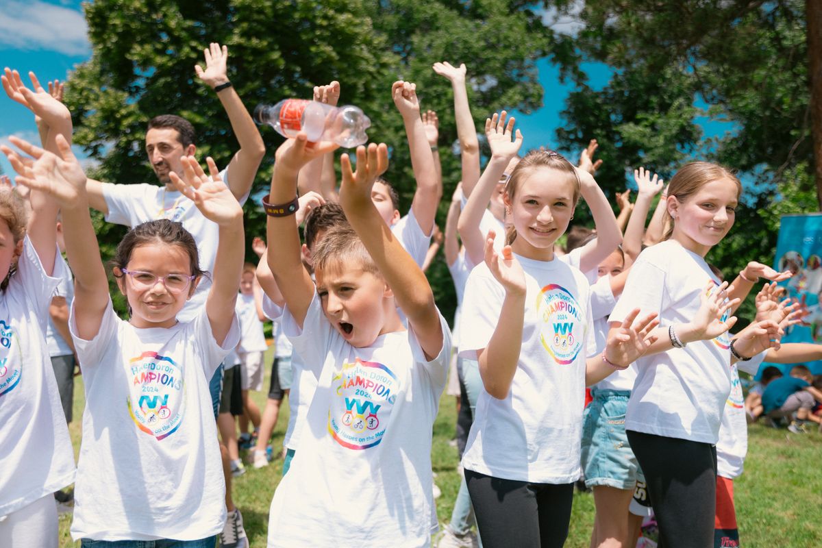 Photo by Aleksandar Andreev on Pexels Group of cheerful children raising hands in a park during a sunny day, wearing t-shirts with event logos. - Photo by Aleksandar Andreev on Pexels