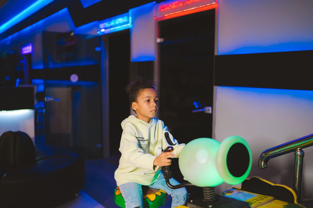 Photo by Anastasia Shuraeva on Pexels Child playing a video game in an arcade, focused on the screen. - Photo by Anastasia Shuraeva on Pexels