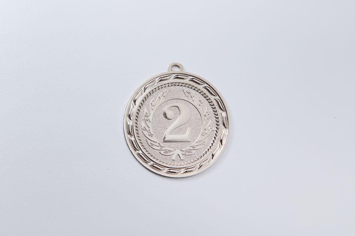 Photo by DS stories on Pexels Close-up of a silver second place medal with an engraved number 2 on white background. - Photo by DS stories on Pexels