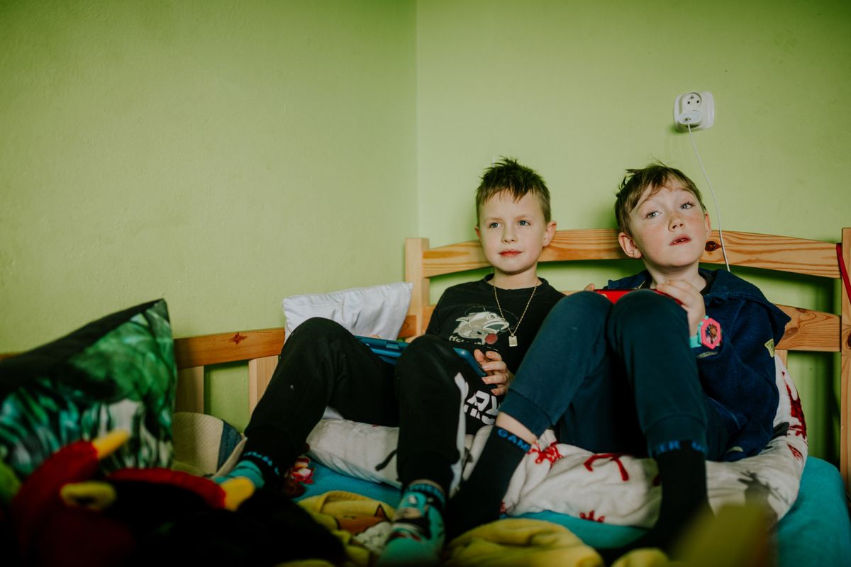 Photo by Helena Jankovičová Kováčová on Pexels Two young boys sitting comfortably on a bed indoors, sharing a peaceful moment. - Photo by Helena Jankovičová Kováčová on Pexels