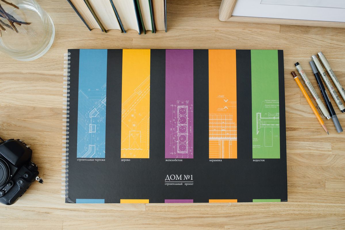 Photo by Ivan S on Pexels Design and architecture workbook with colorful blueprints on a wooden desk. - Photo by Ivan S on Pexels