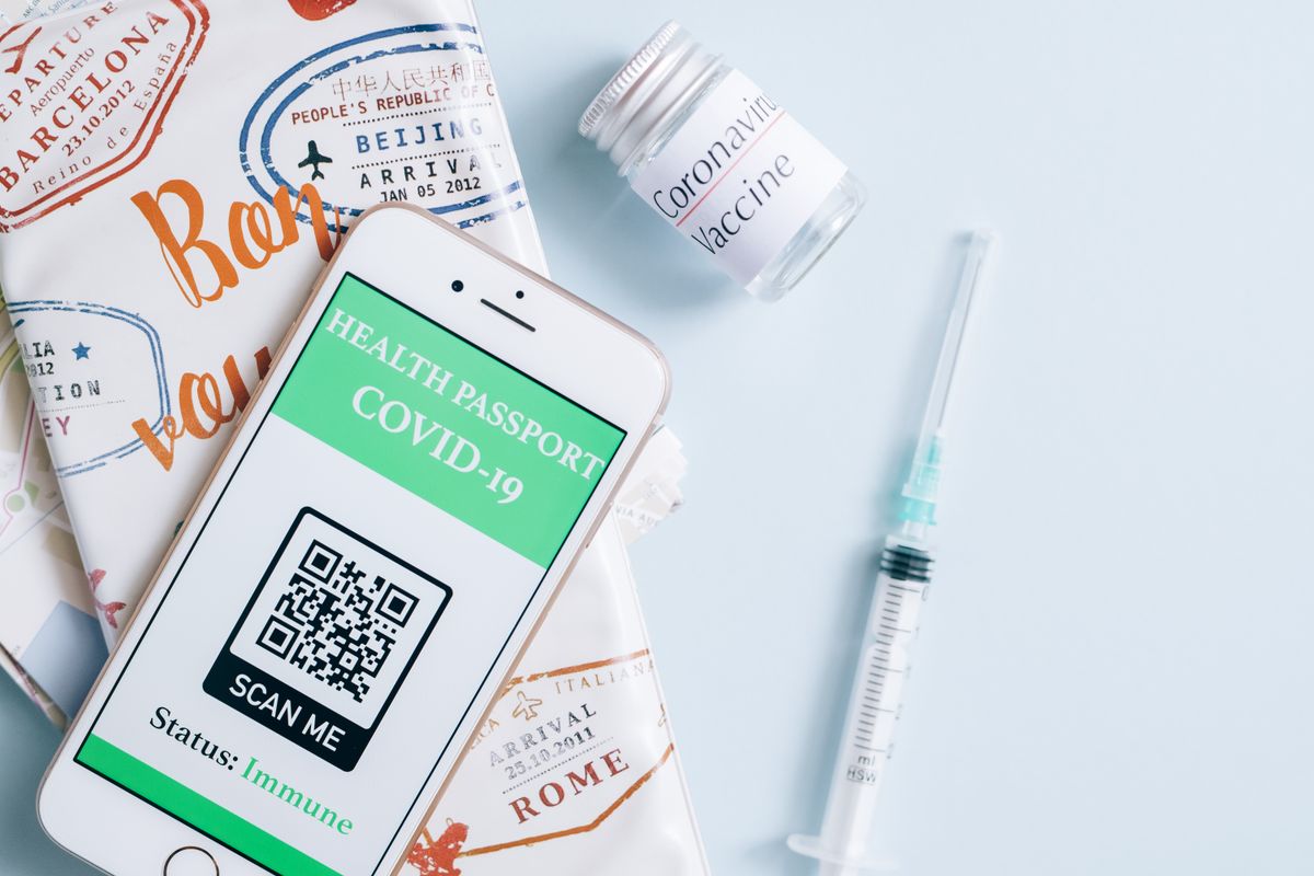Photo by Leeloo The First on Pexels Image of a smartphone displaying a COVID-19 health passport next to a vaccine vial and syringe, ready for travel. - Photo by Leeloo The First on Pexels
