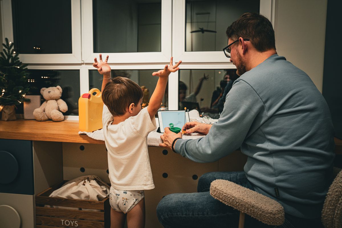 Photo by Pexels User on Pexels A father and child enjoy quality time together at a desk by a window in the evening. - Photo by Pexels User on Pexels