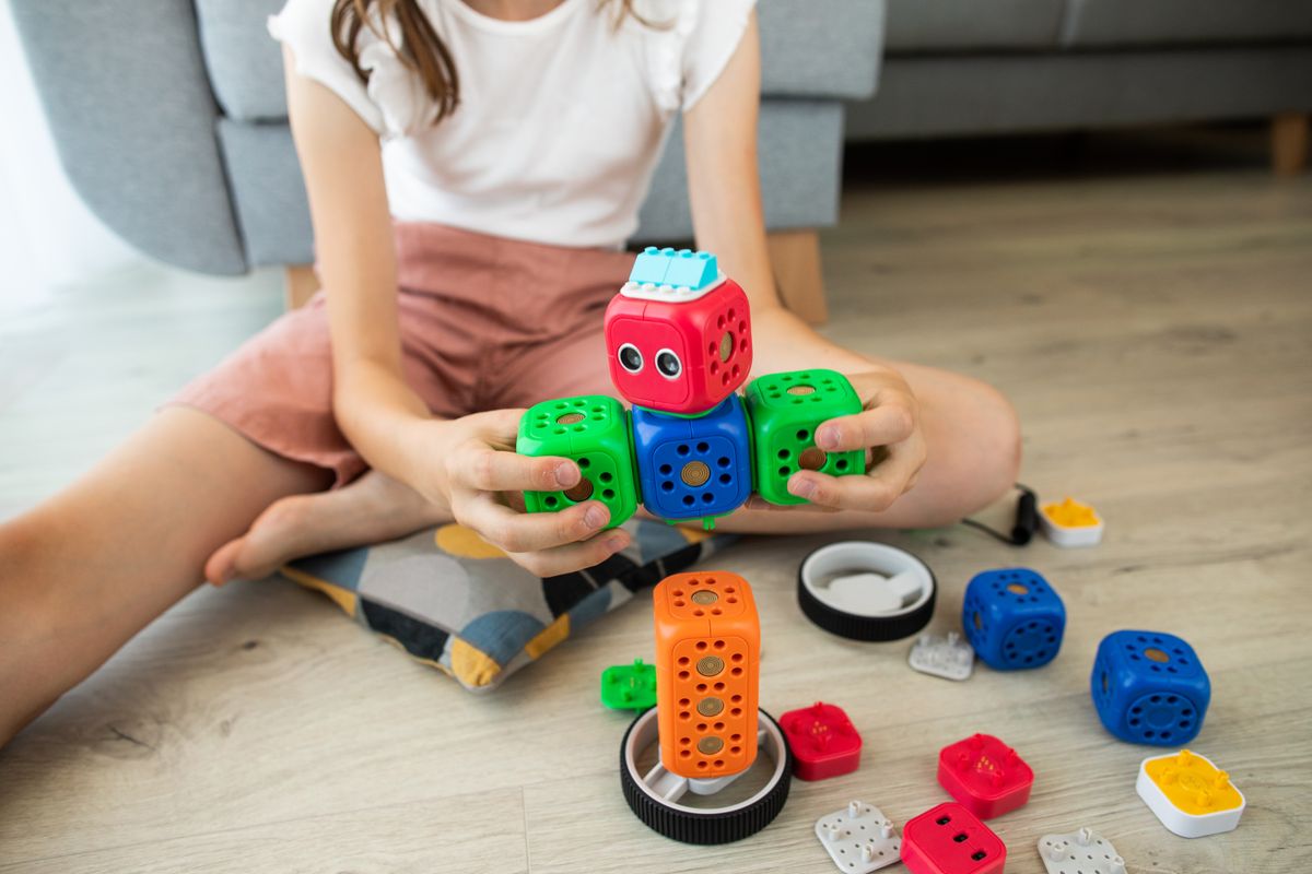 Photo by Robo Wunderkind on Pexels A child enjoys creativity indoors playing with a colorful robot toy, enhancing learning and fun. - Photo by Robo Wunderkind on Pexels