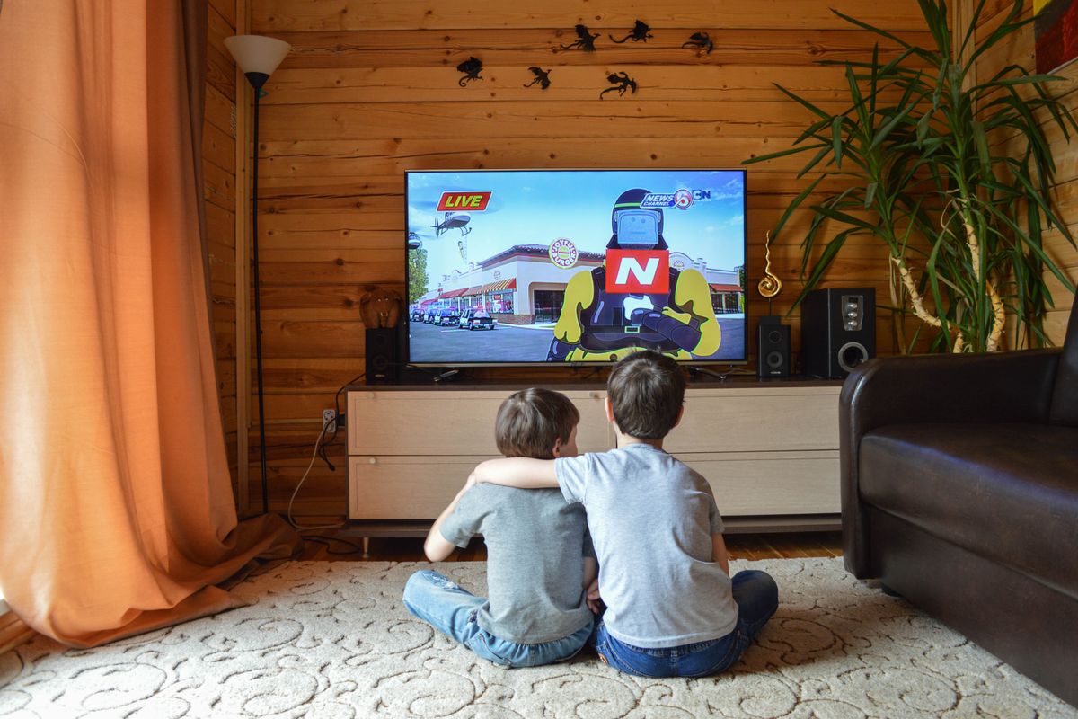Photo by Vika Glitter on Pexels Back view of unrecognizable little children in similar casual outfits resting on floor at home and hugging while watching cartoon on TV - Photo by Vika Glitter on Pexels