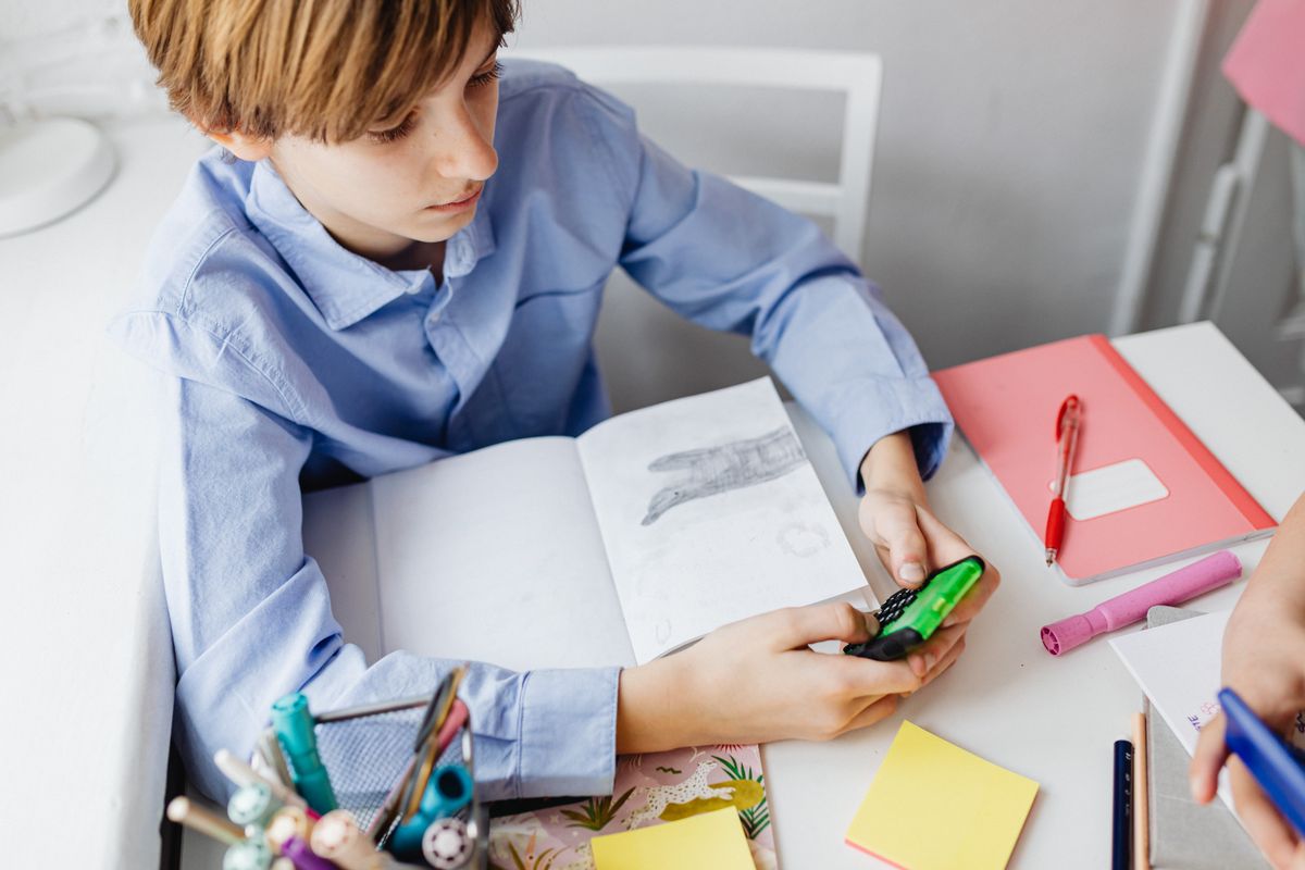 Photo by www.kaboompics.com on Pexels Boy using a calculator while studying at a desk with school supplies, focusing on mathematics. - Photo by www.kaboompics.com on Pexels